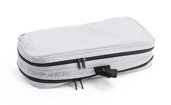 A filled and zipped closed Northwest Sky (light grey) Aether Small Aeronaut 30 Packing Cube showing the all-fabric side.